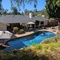Pool yard with hot tub.