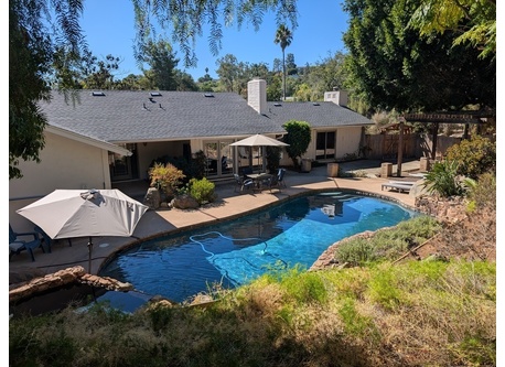 Pool yard with hot tub.