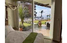 View to patio, pool, and ocean from master bedroom