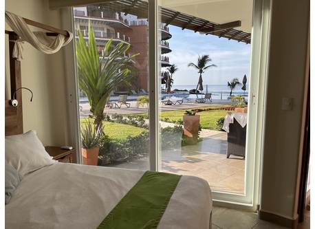 View to patio, pool, and ocean from master bedroom