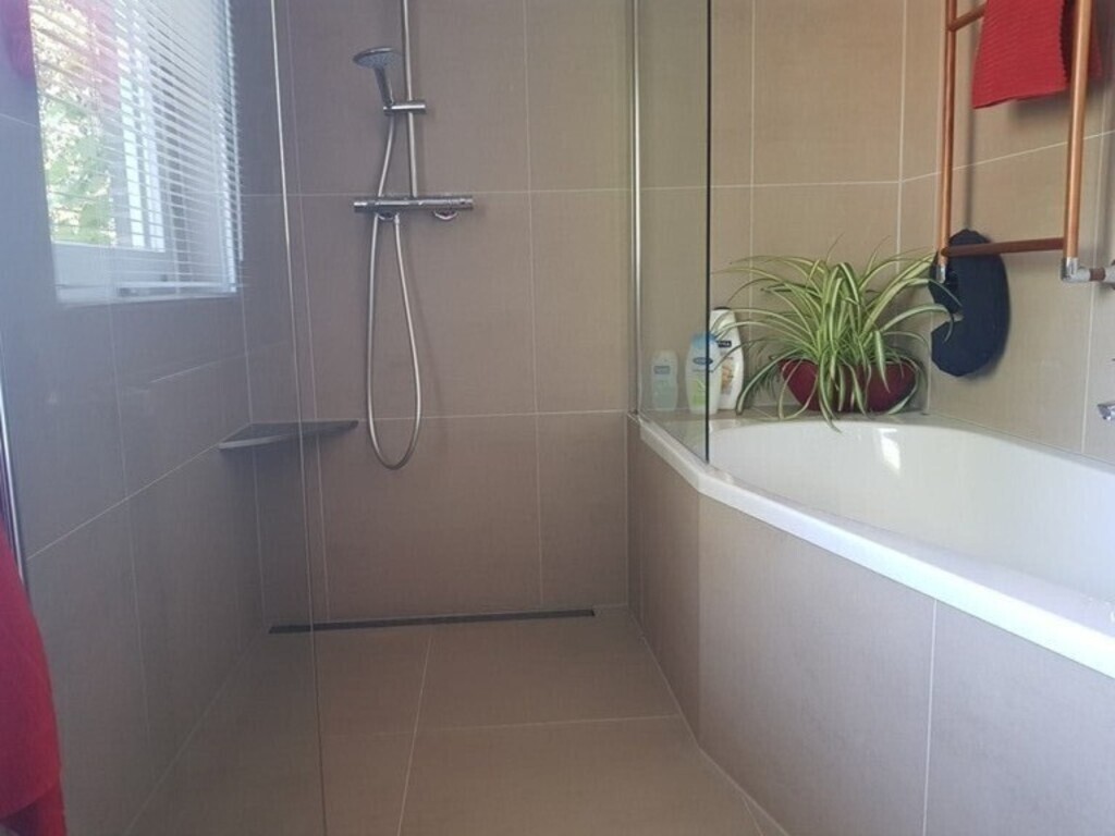 the same bathroom with walk in shower and bath on the first floor