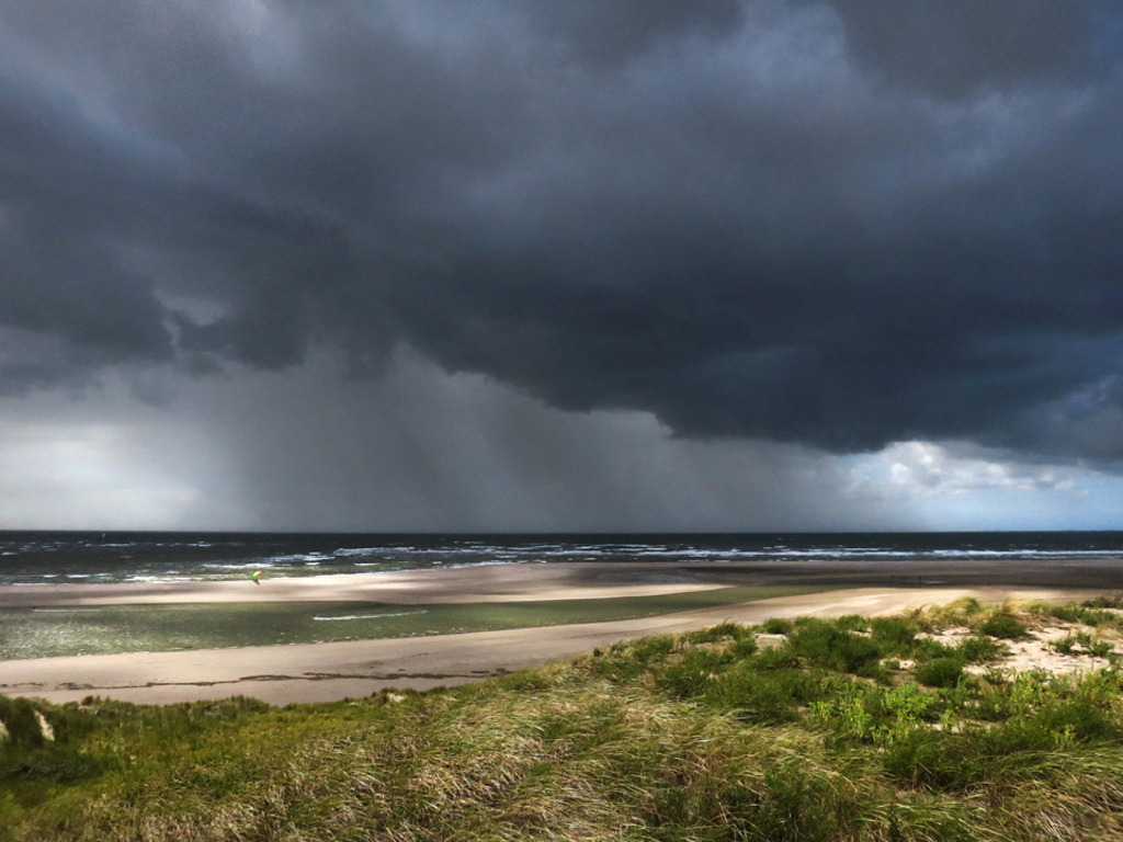 Maasvlakte beach with lonely kite surfer.