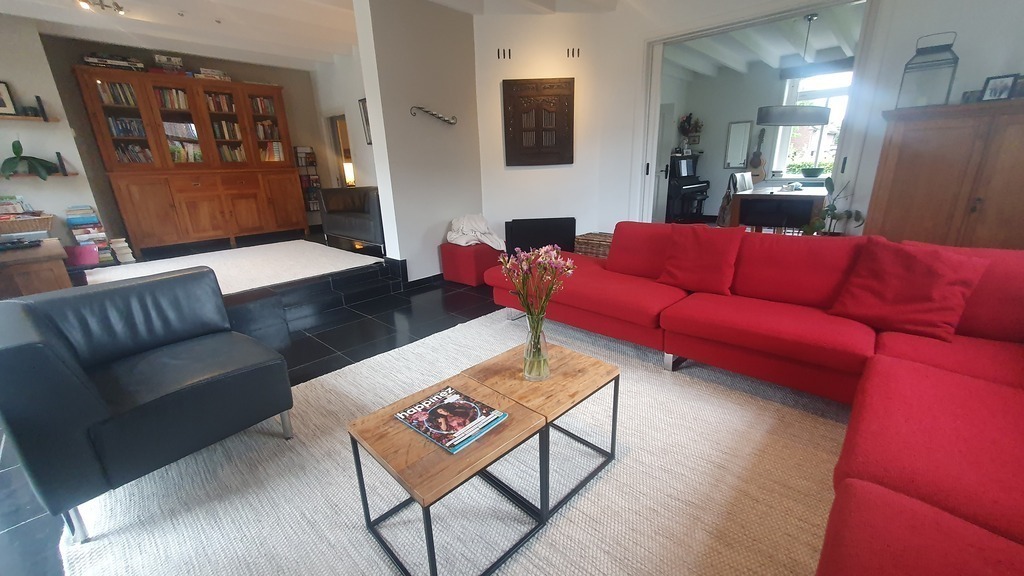 Living room and TV/kids corner. Kitchen entrance visible at the back.