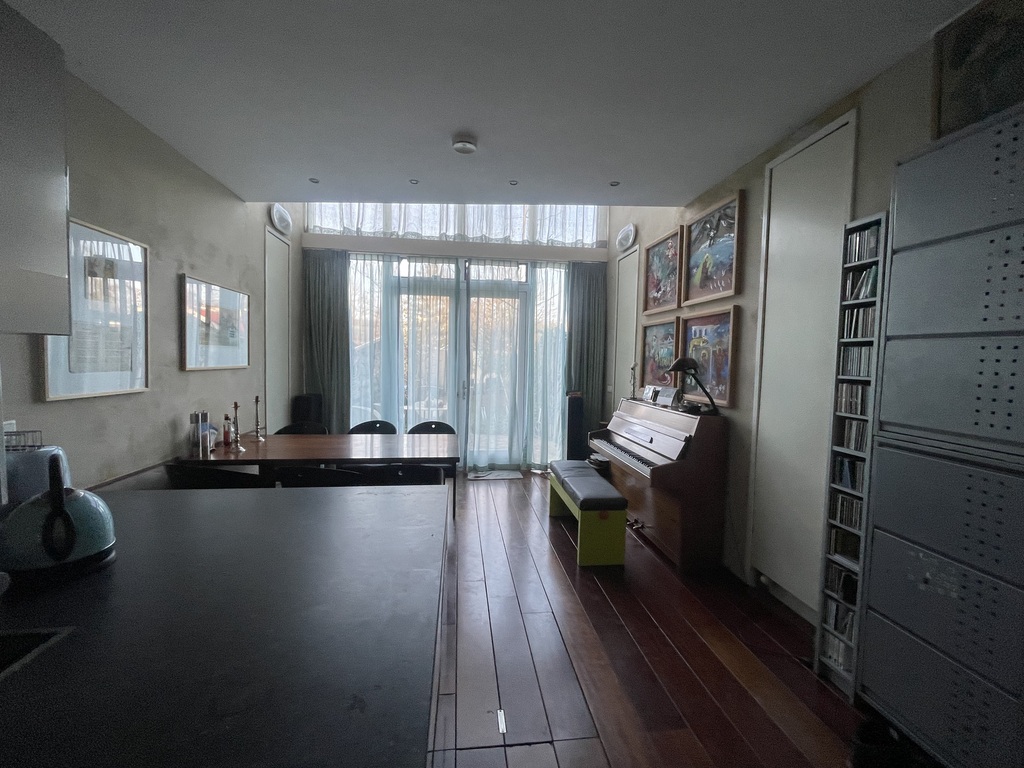 view from the kitchen towards dining room with piano