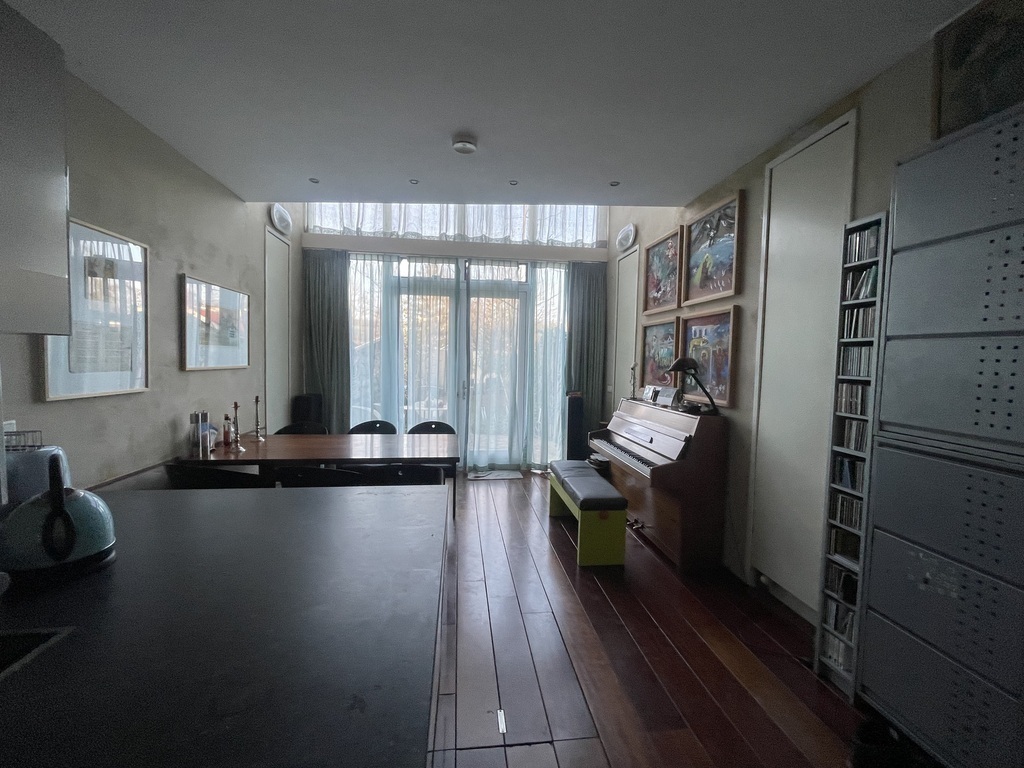view from the kitchen towards dining room with piano