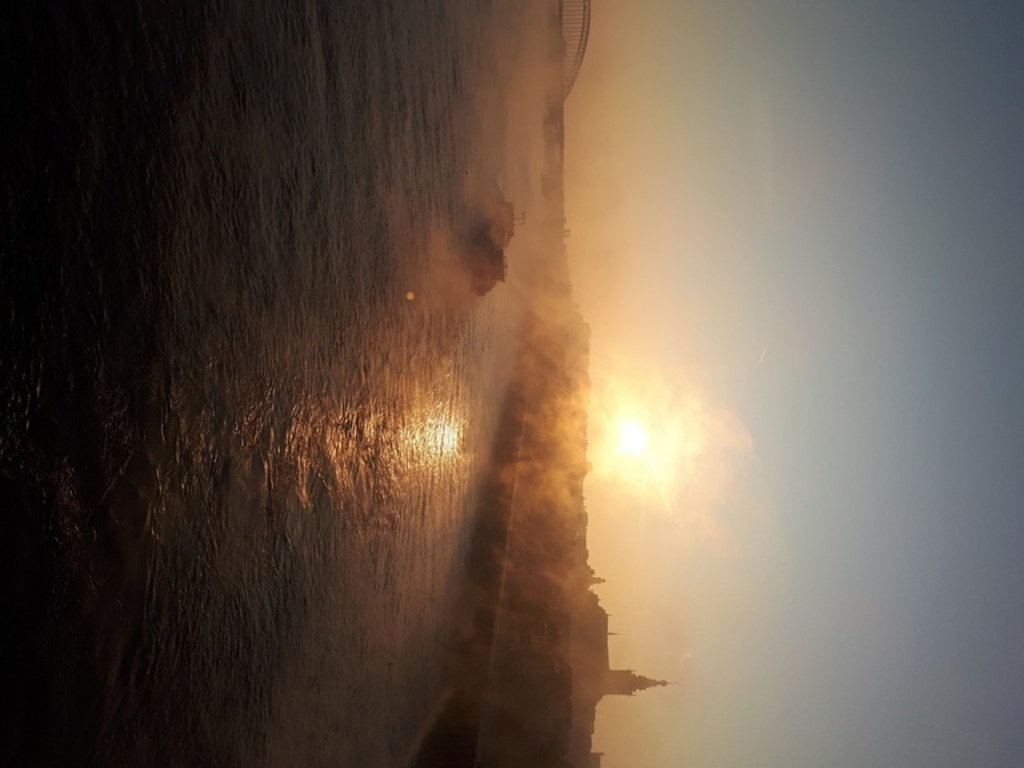 The river Waal with a view of the city centre early in the morning. 