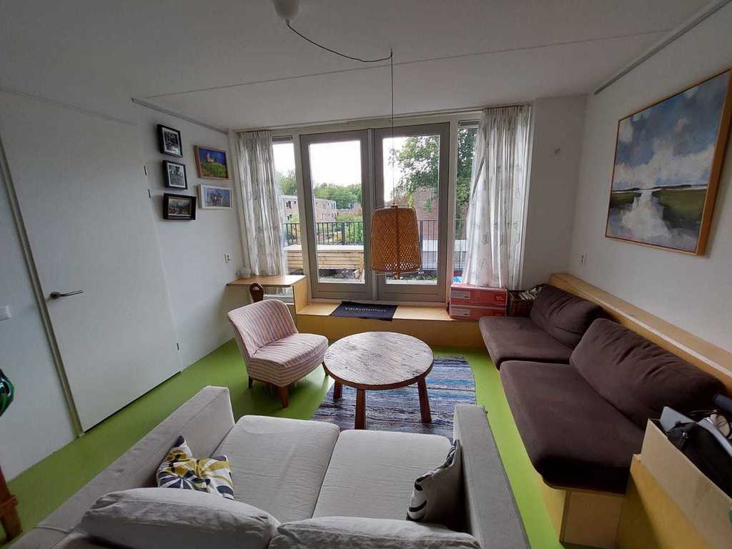 Living area on the first floor with doors to the balcony
