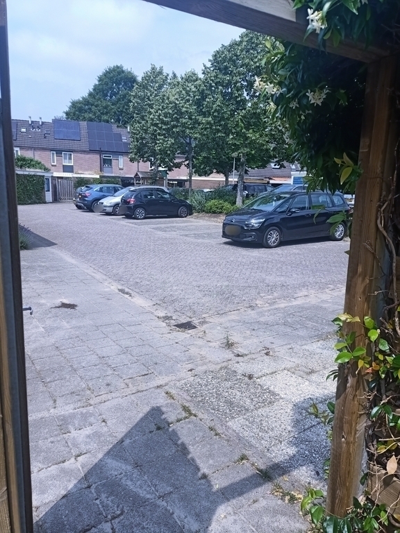 Parking lot behind the house. There is one private parking space (right side outside the picture)