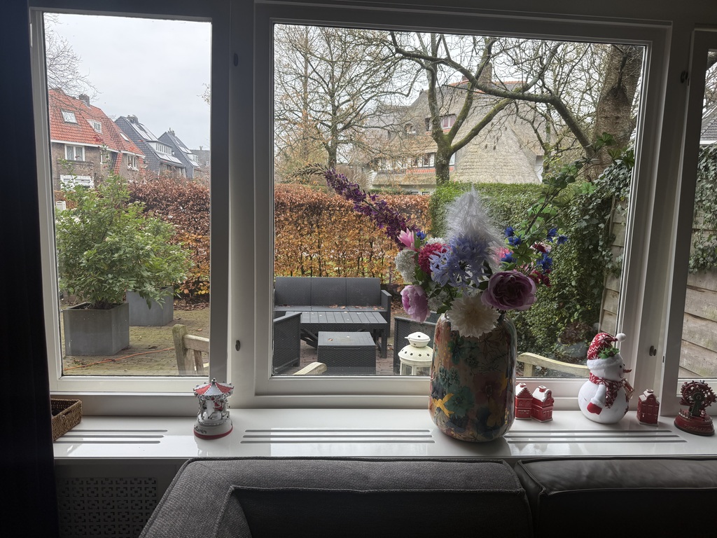 View front side of the house, garden with lounge area