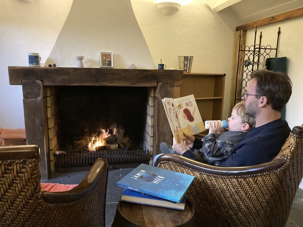 Reading books by the fire place in our gardenhouse