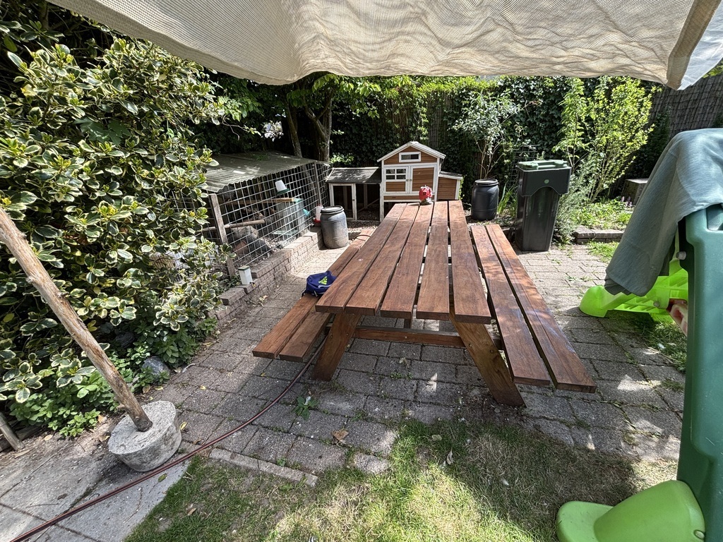 Picknick table in the garden. The chickens in the background