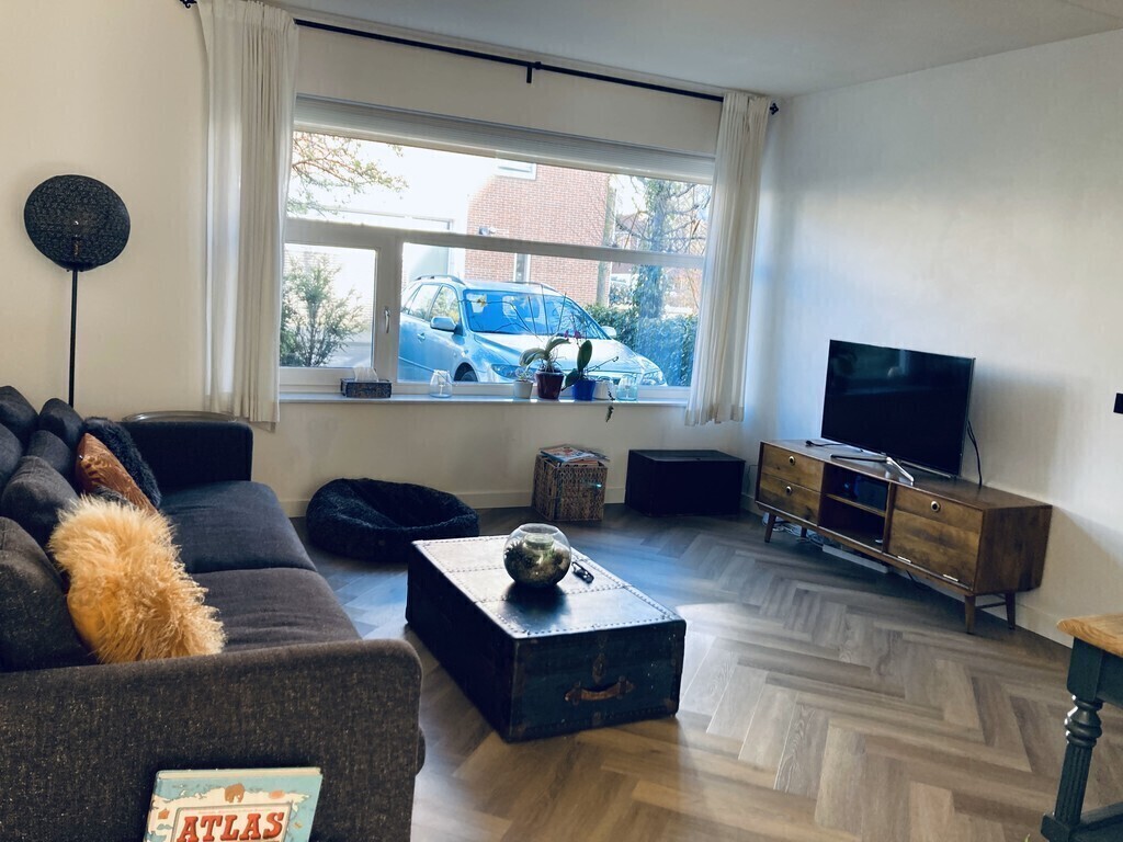 Living room with view towards front garden & parking space