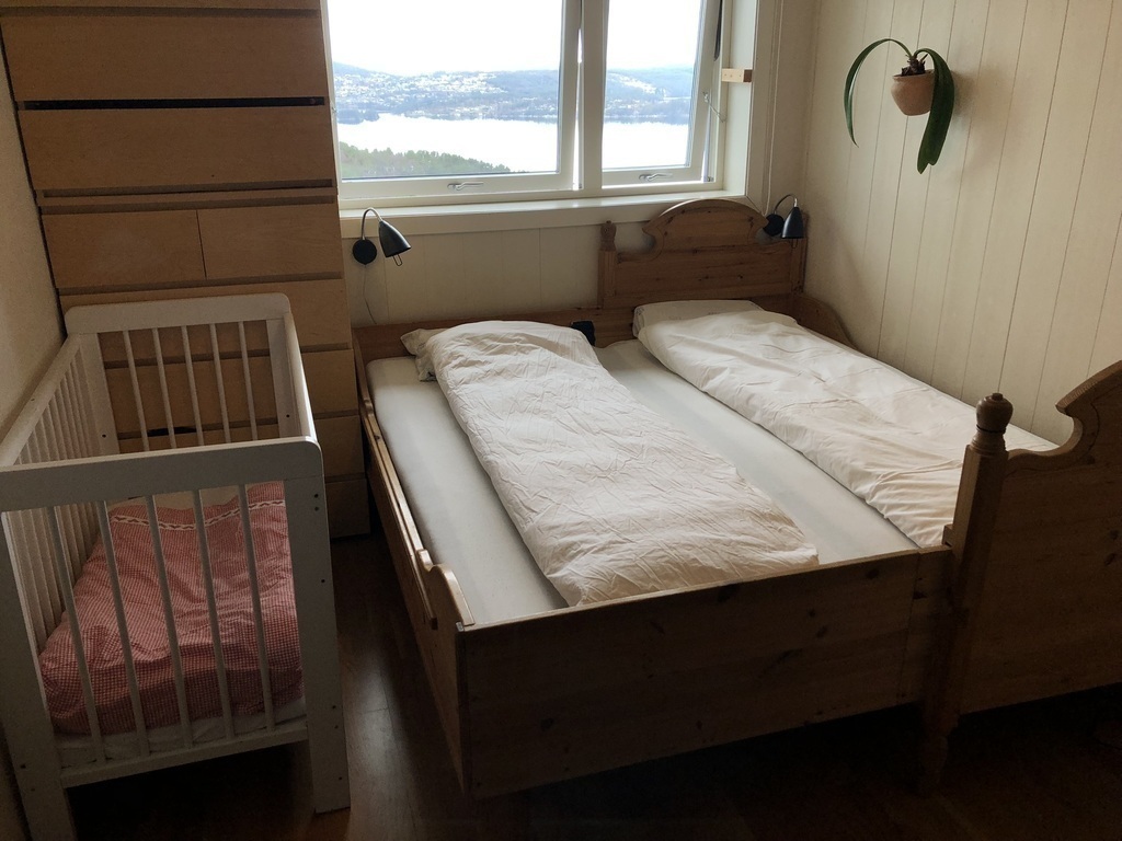Bedroom 1 upstairs, with 180 cm bed and a baby's cot