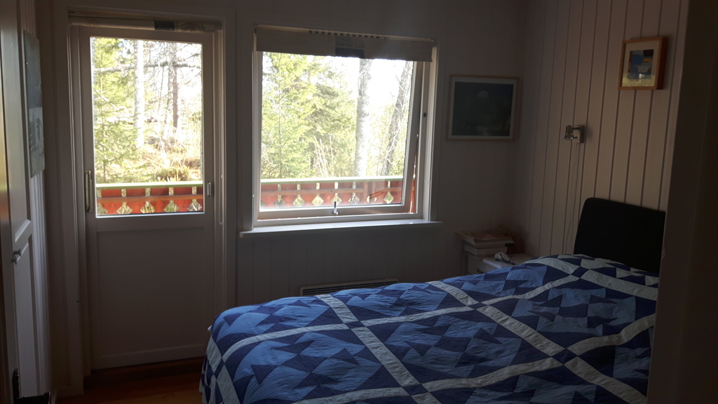 main bedroom with door to east facing balcony