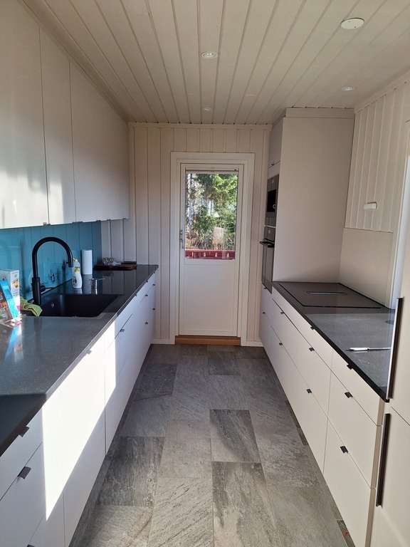 modern kitchen with door to east facing balcony