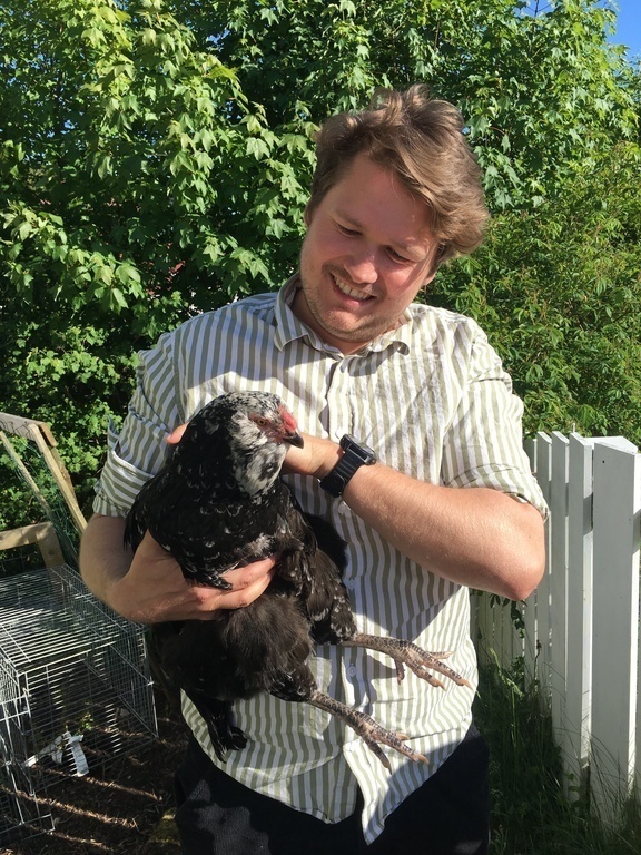 Our son Harald with one of our four charming hens. They live in a small house in the garden