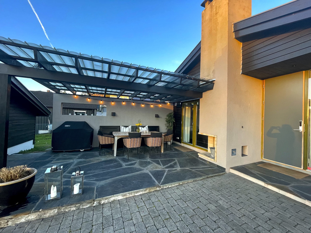 Pergola with dining table and barbecue
