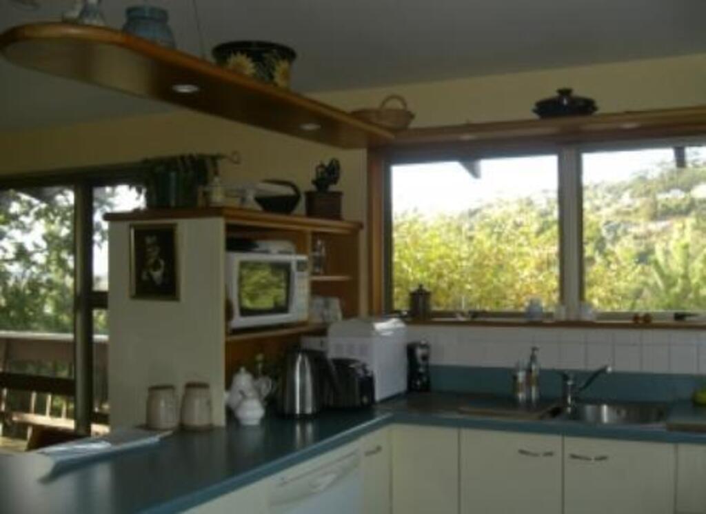 The well equipped and convenient kitchen looks out across the valley, with another window offering a panoramic view of the Po...