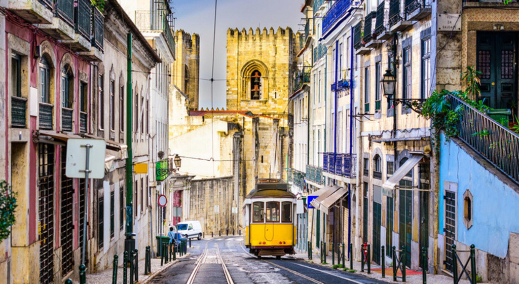 Tram and Lisbon's Cathedral in the background - Catch the 28 tram 15 minutes in the Green subway line (direct)