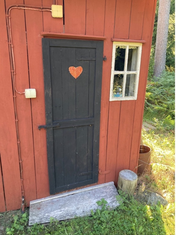 Outhouse/natural toilet next to wood shed