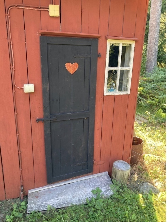 Outhouse/natural toilet next to wood shed