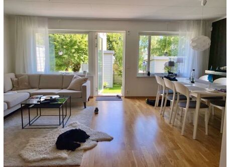 Living room with sofa and dining area.