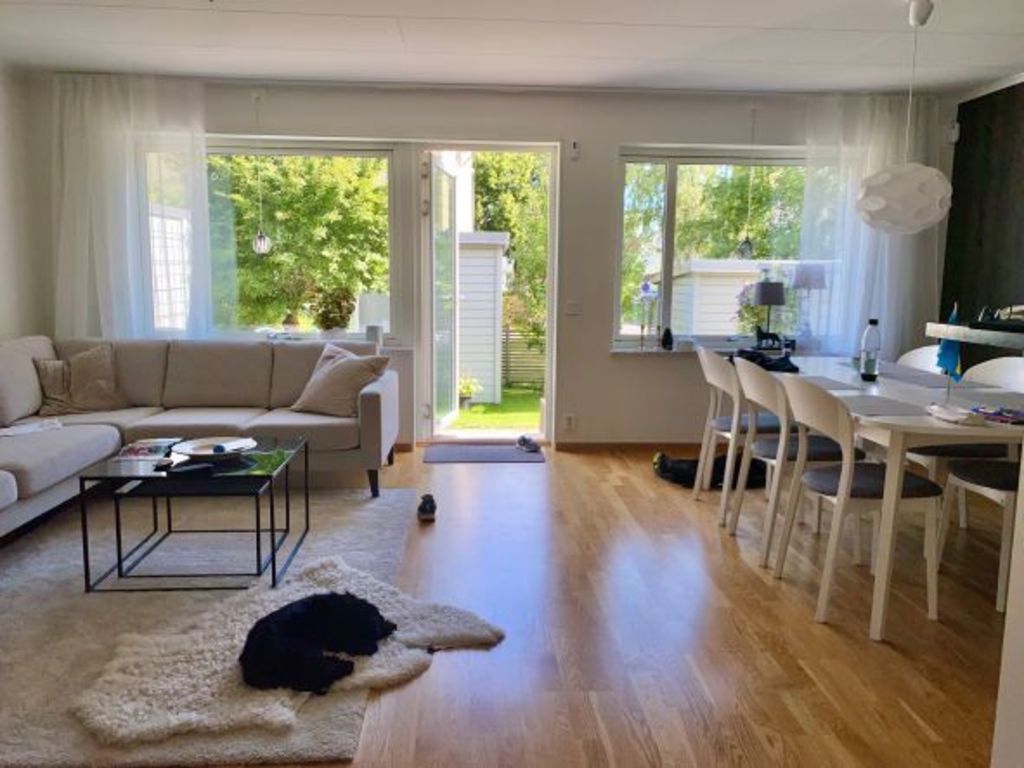 Living room with sofa and dining area.