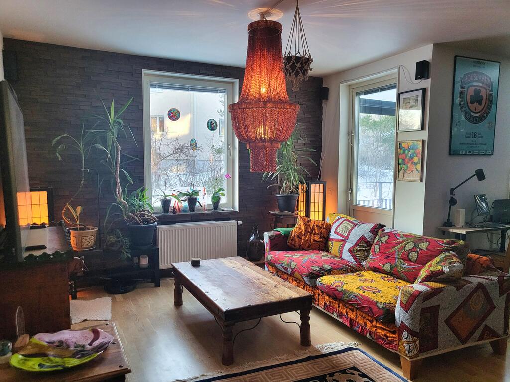 Livingroom facing balkony and kitchen entrance