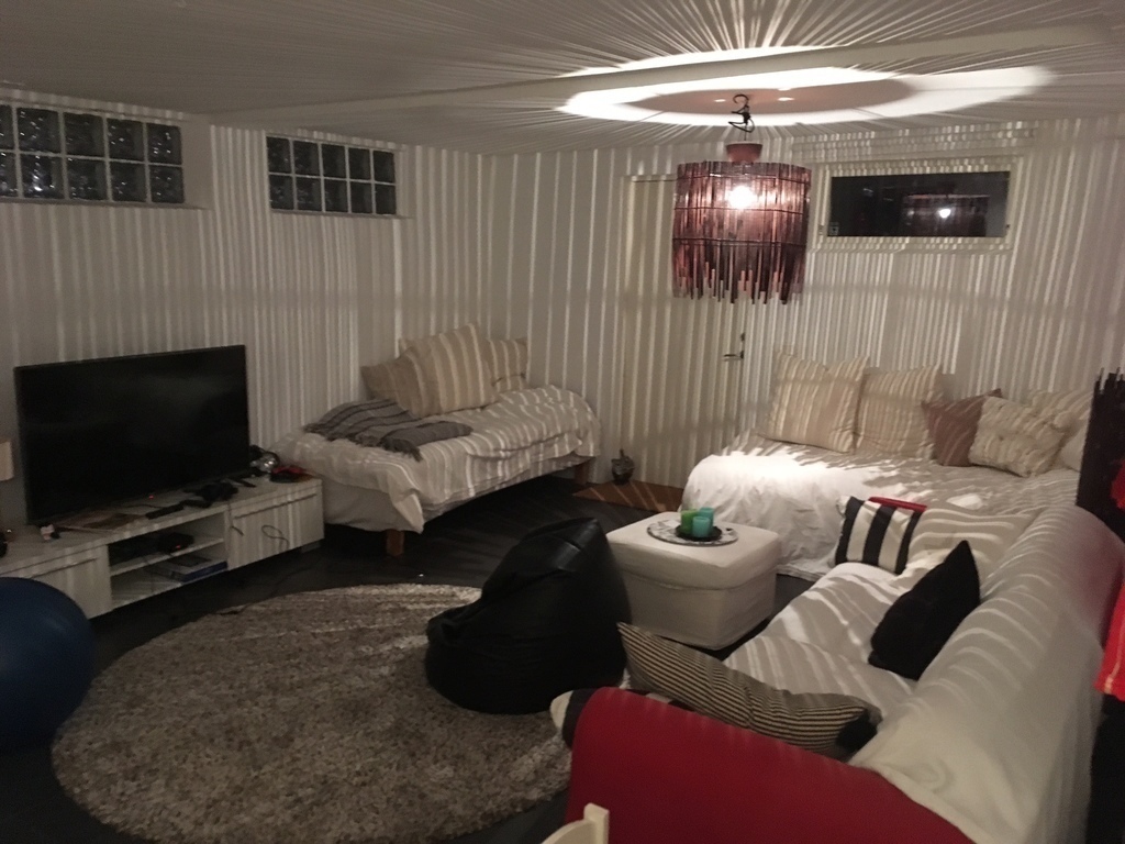 Downstairs there is a large bed, a large sofa and a TV with playstation