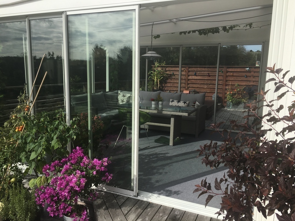 Our deck with the conservatory where we usually eat outside in summer, spring and early autumn. 