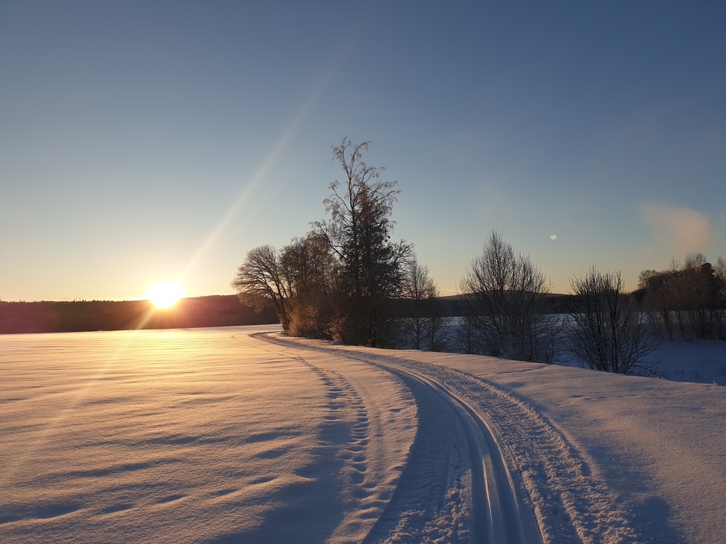 cross country skiing on a frozen lake in sunset