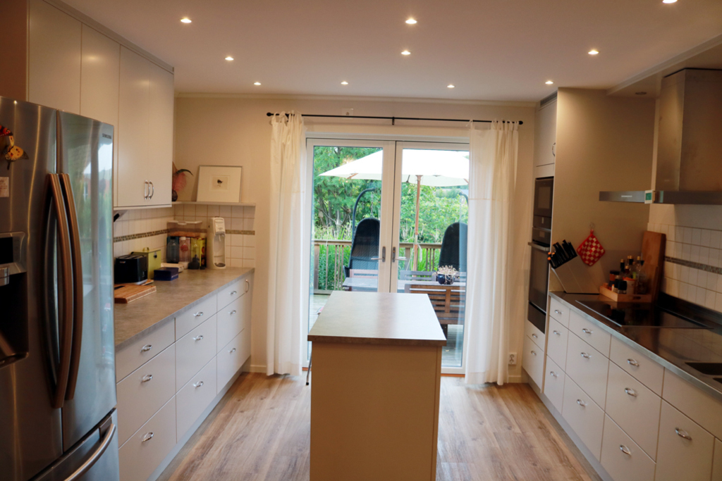 The kitchen. At the far end doors to the patio.