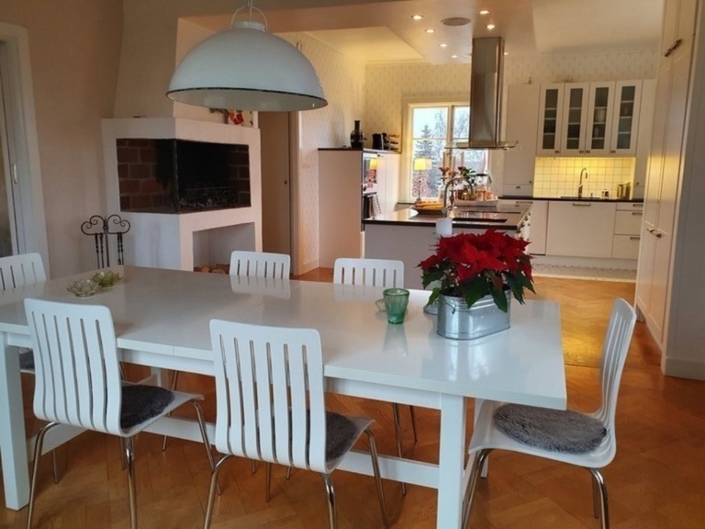 A combined kitchen and dining room with a fireplace