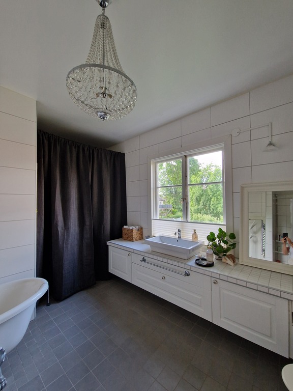 Large bathroom with shower, bathtub and sauna