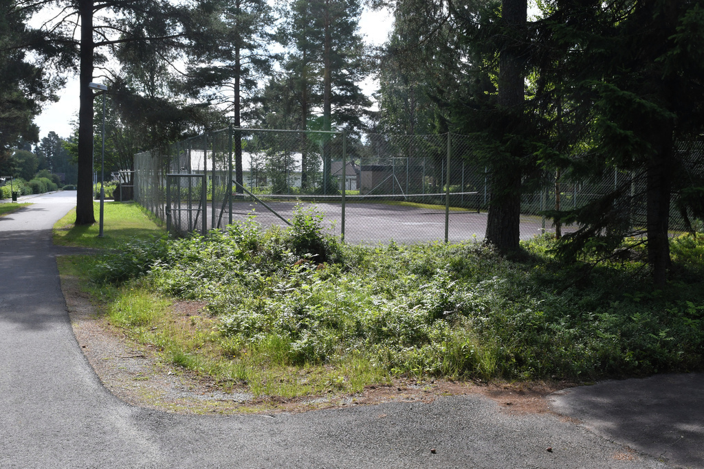 Public tennis court behind house