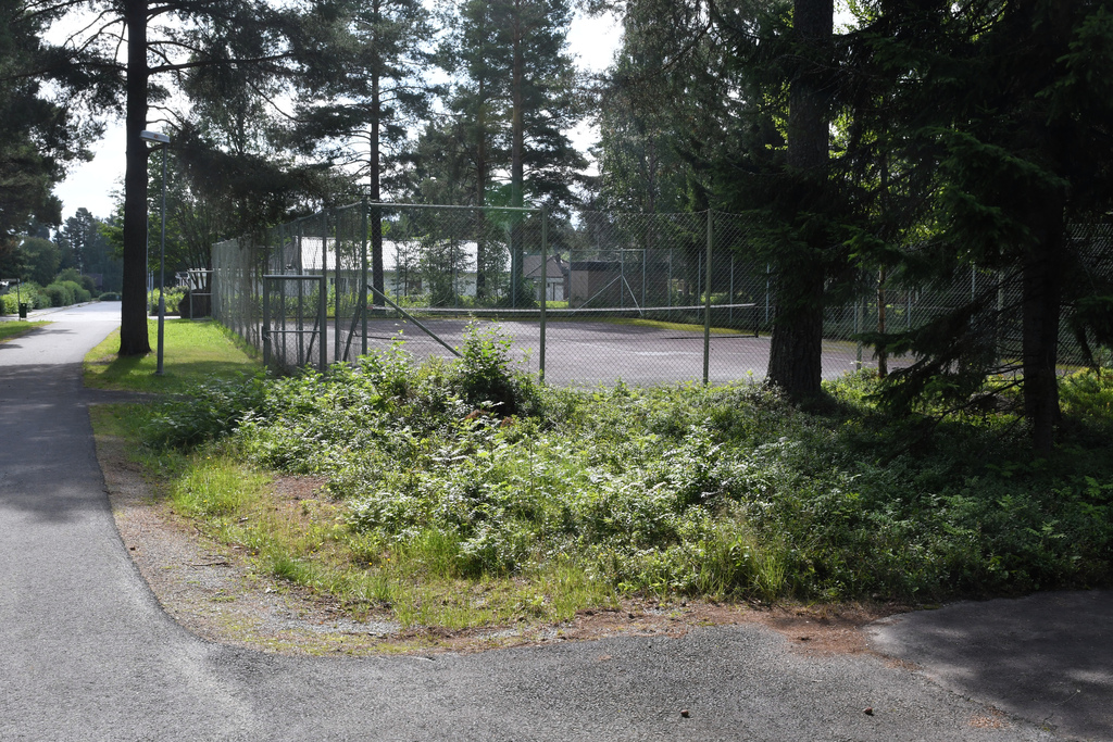 Public tennis court behind house