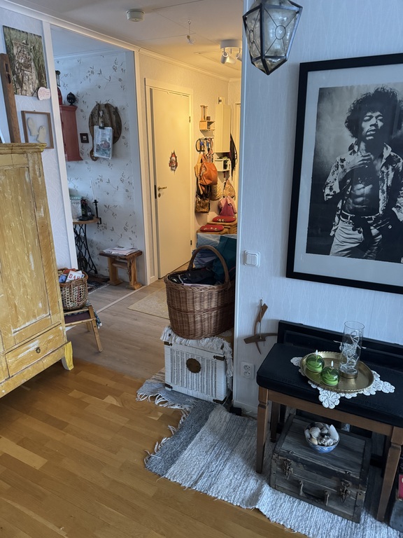 From the livingroom, the kitchen slightly to the left and the hall to the right