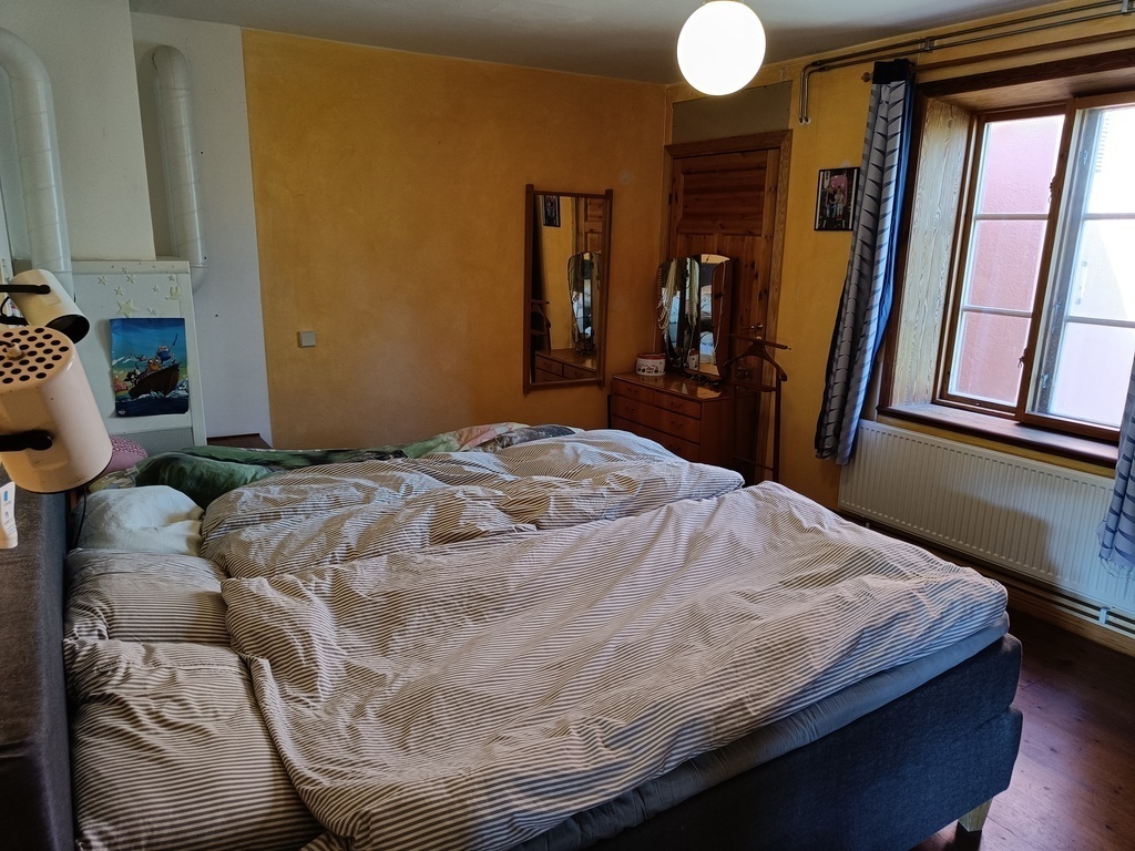 Master bedroom with a kingsize bed and an extra bed as well.