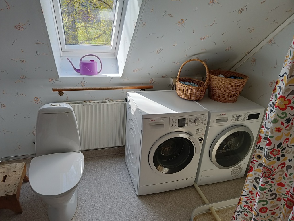 Second floor bathroom with a shower, washing machine and a tumble dryer.