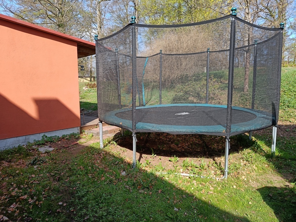 Huge trampoline in the backyard.
