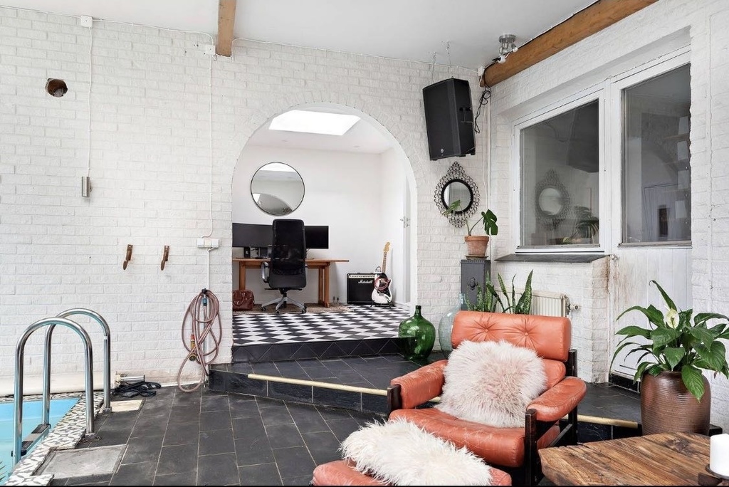 Pool room with sauna and seating area  