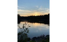 Sunset by a little lake in the forest