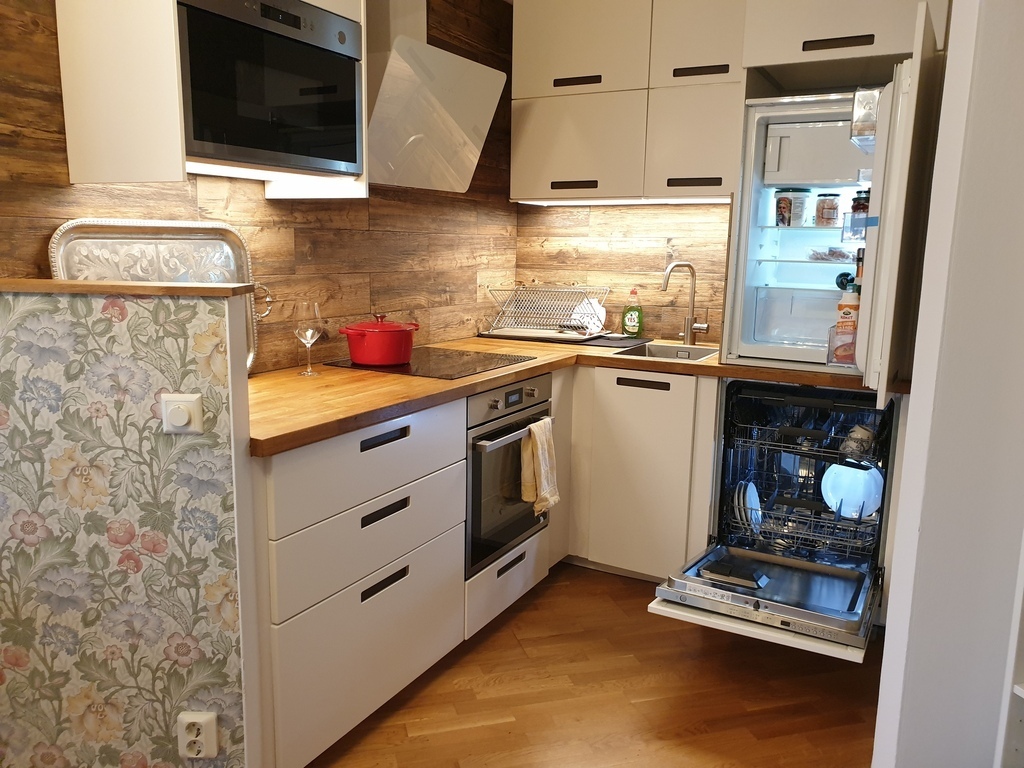 Kitchen with microwave, stove, oven, refrigerator and dishwasher.