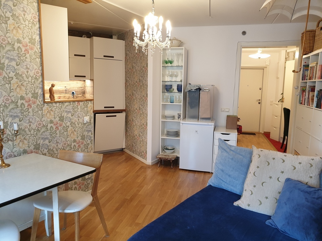 Living room with freezer, crockery, recycling.