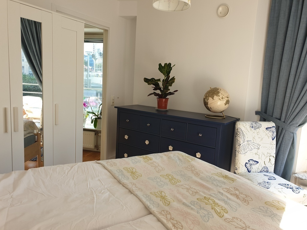 Bedroom with wardrobe and dresser.