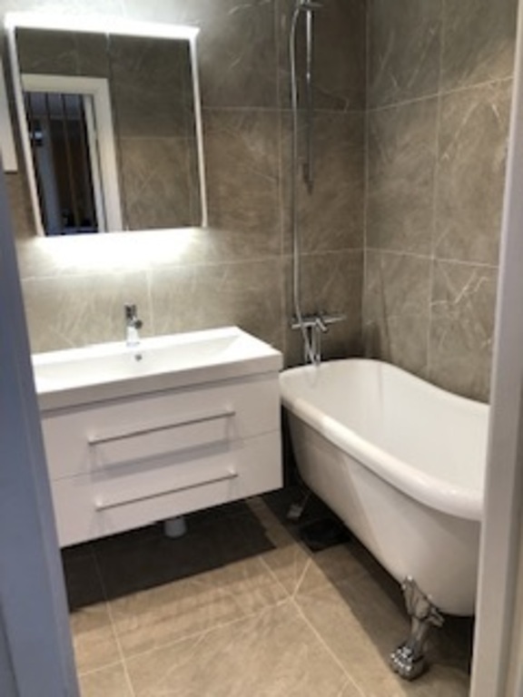 Upstairs bathroom with bathtub