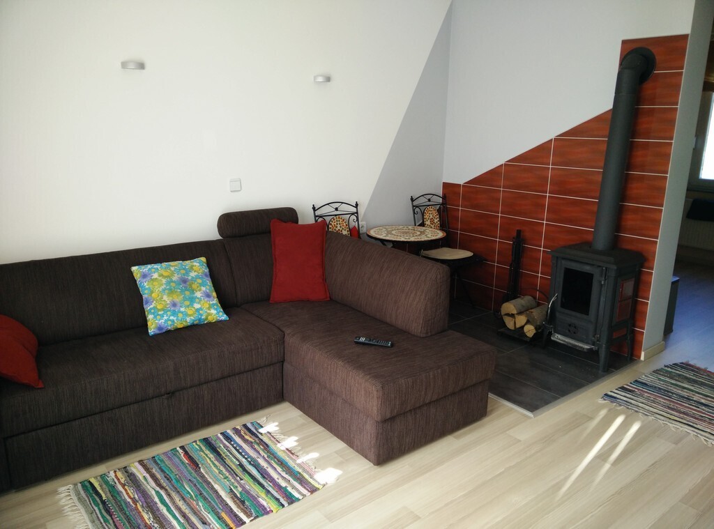 Sofa with a fireplace in the livingroom. 2 people can also sleep here. We love to sleep here when the fireplace is on.