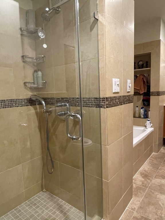Main bathroom has both bathtub & separate shower