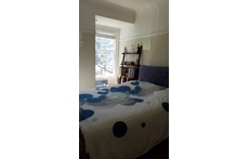 Bedroom in the early morning light -- the mattress is queen sized.