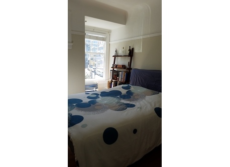 Bedroom in the early morning light -- the mattress is queen sized.